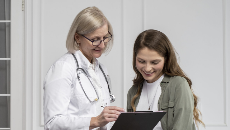 Doctor helping female patient in office